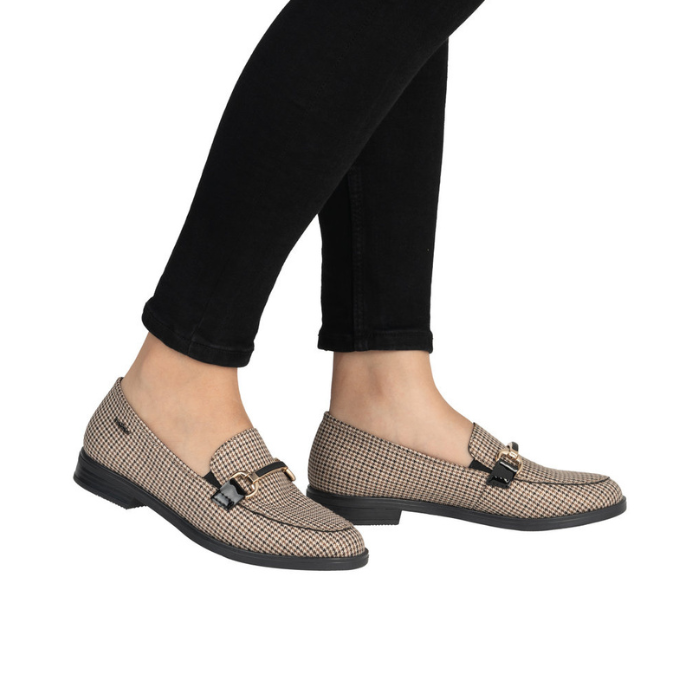 Brown houndstooth pattern loafers worn with black pants.