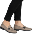 Brown houndstooth pattern loafers worn with black pants.