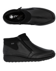 Pair of black ankle boots with side zippers and elastic cuff.