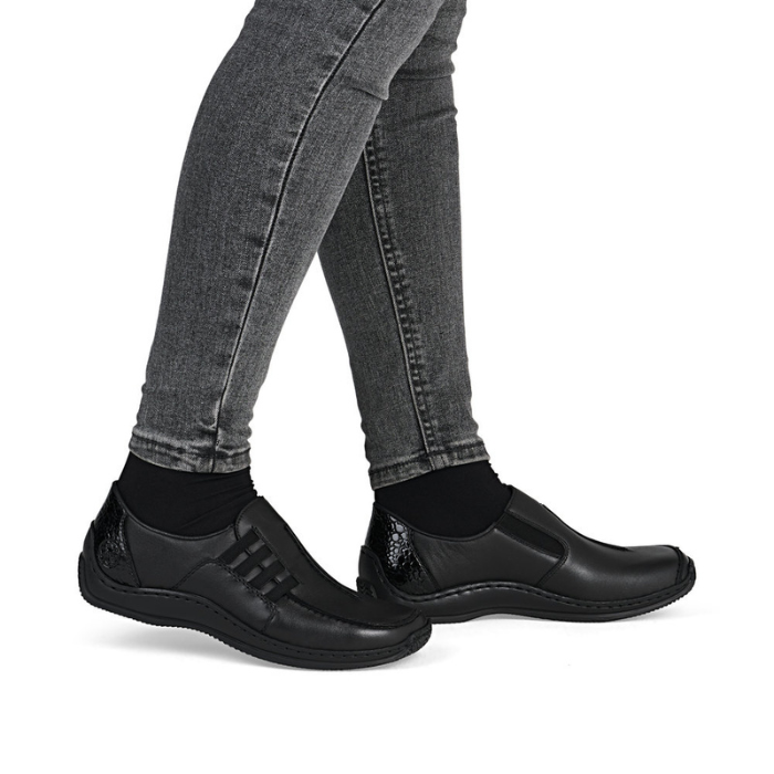 Black shoes worn with grey jeans.
