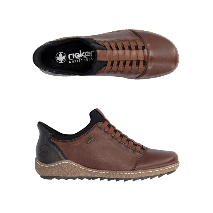 Pair of Brown leather slip on shoes with black accents, black Rieker logo'd footbed, faux elastic lace details and a treaded black outsole.
