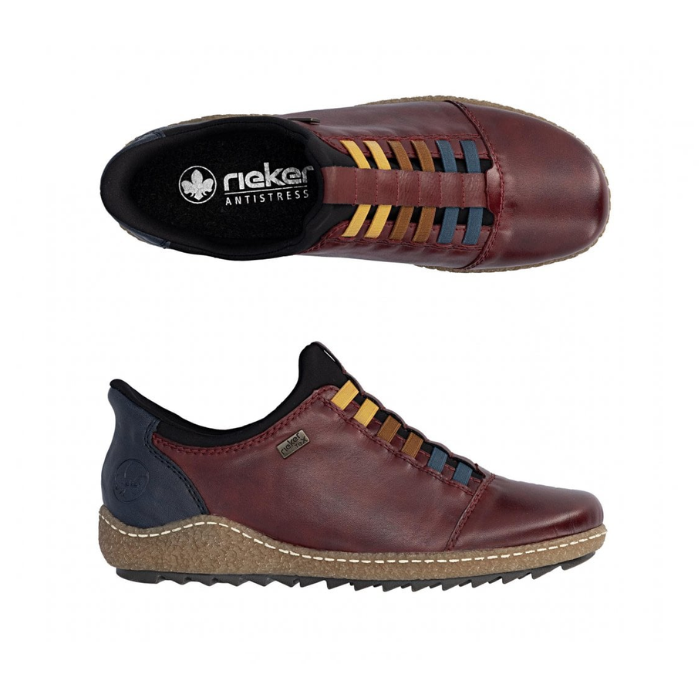 Pair of Red leather slip on shoe with navy accents, faux yellow, brown and blue elastic lace details, black Rieker logo&#39;d footbed and a treaded black outsole.