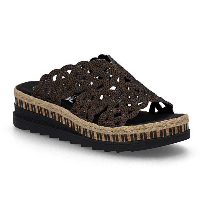 Brown perforated slide sandal with small black rhinestones, black Rieker logo'd footbed, brown cork midsole with partial jute wrap, black line pattern and a thick black outsole.