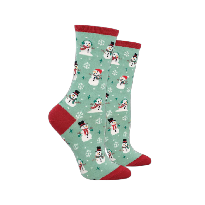 Socksmith Women's Winter Snowman Socks featuring a green background with snowmen and snowflake patterns, red accents on the toes and heels. 