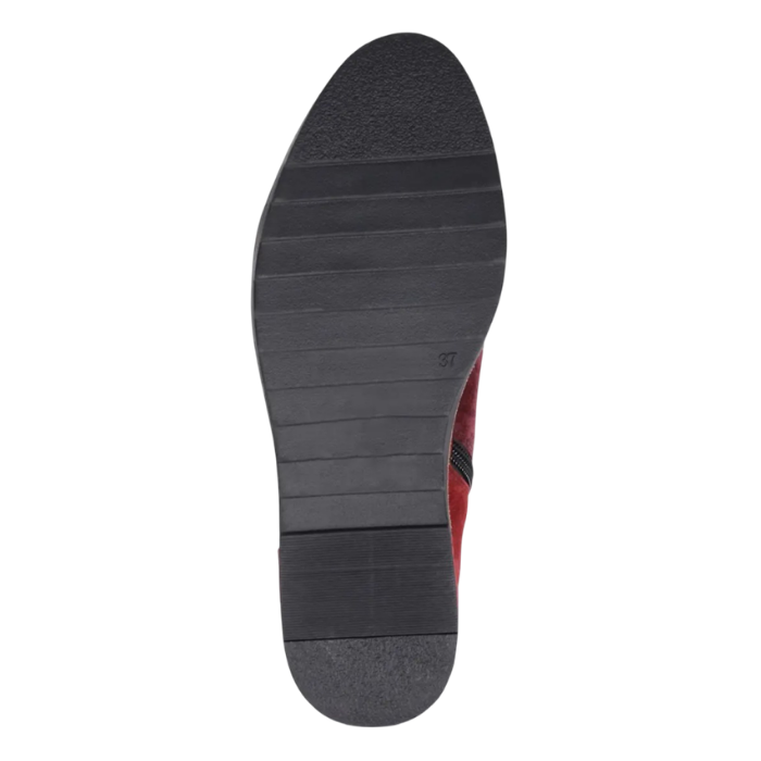 Black rubber light treaded outsole of ankle boot.