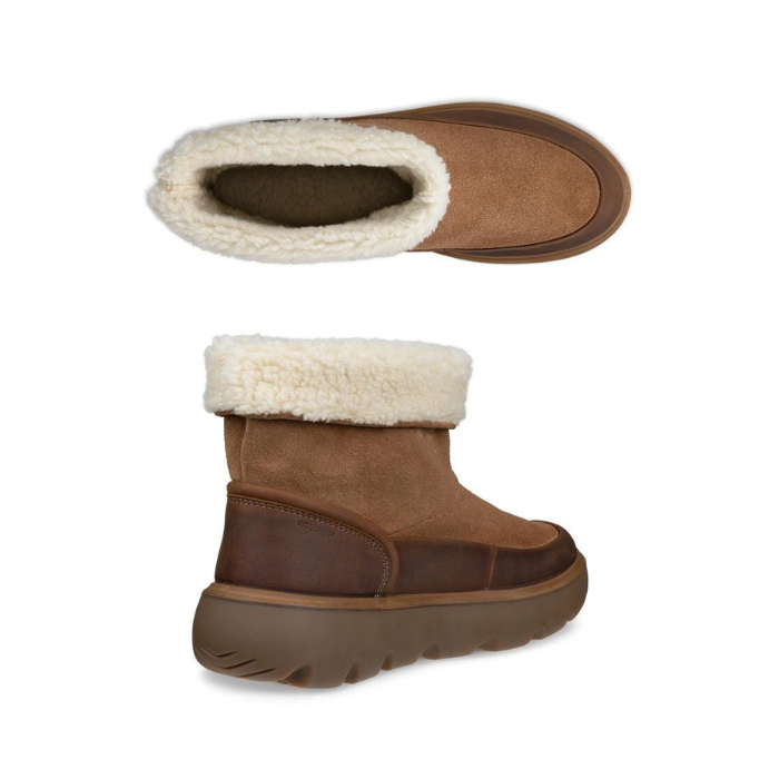 Pair of brown suede ankle boots with a thick brown lugged outsole and a fluffy cream faux fur collar and lining.