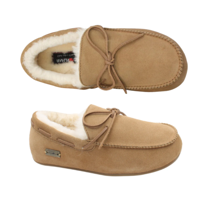 A pair of tan suede slip-on moccasins with a soft cream shearling lining, leather lacing and rubber outsole.
