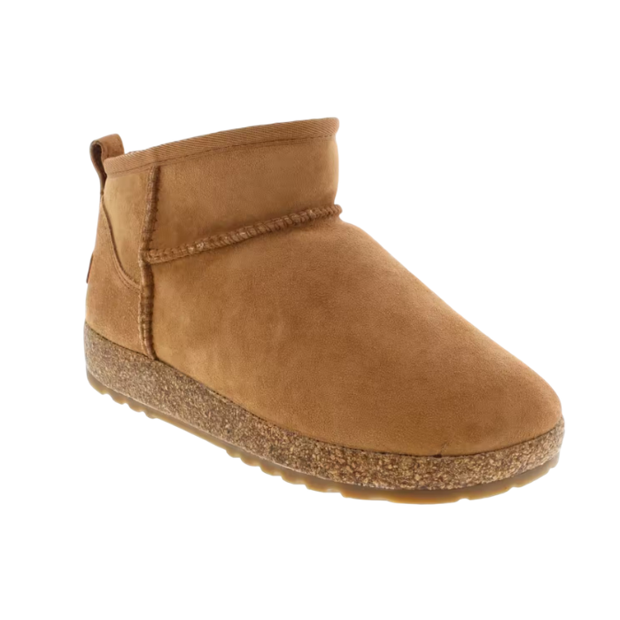 A  tan suede ankle boot with a cork midsole, moccasin style accent stitching and tan outsole.