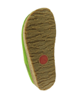 The textured brown rubber outsole of a green clog, showing a circular red Haflinger logo.