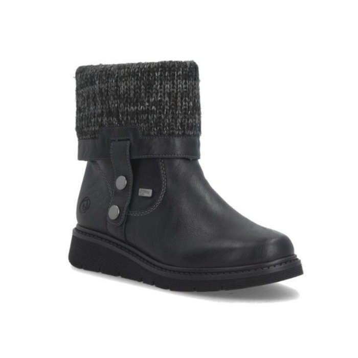 A black ankle boot with a dark gray and black knit cuff, a black strap with silver buttons, and a black outsole.