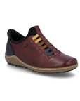 A deep red slip-on shoe with a black heel tab,  colorful elastic laces in yellow, brown, and blue, a  beige textured midsole and black treaded outsole.