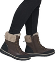 Brown lace-up ankle boot with black treaded outsole.