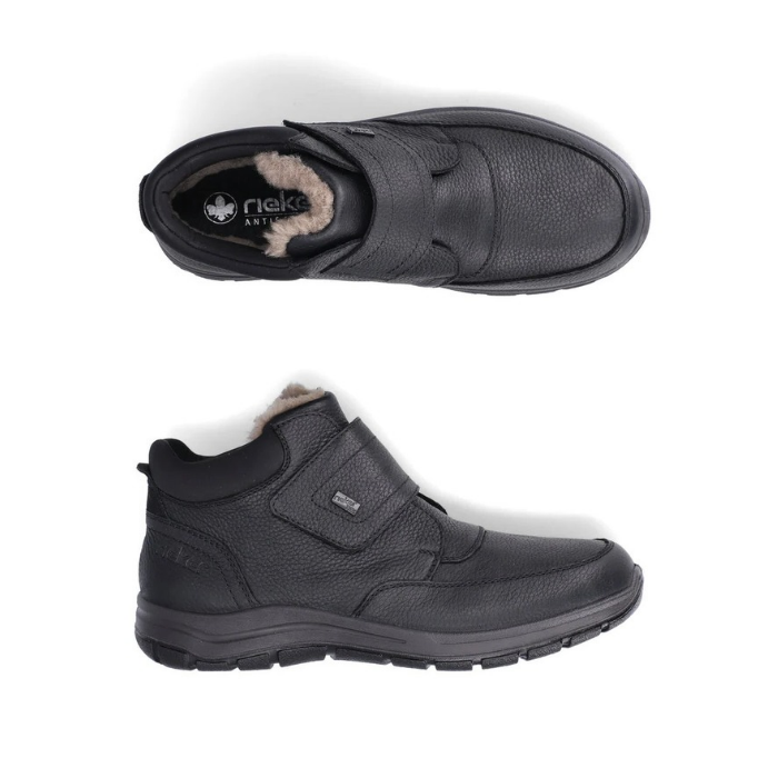 Pair of black leather Velcro shoes with fur cuff, black Rieker logo'd footbed and black treaded outsole.