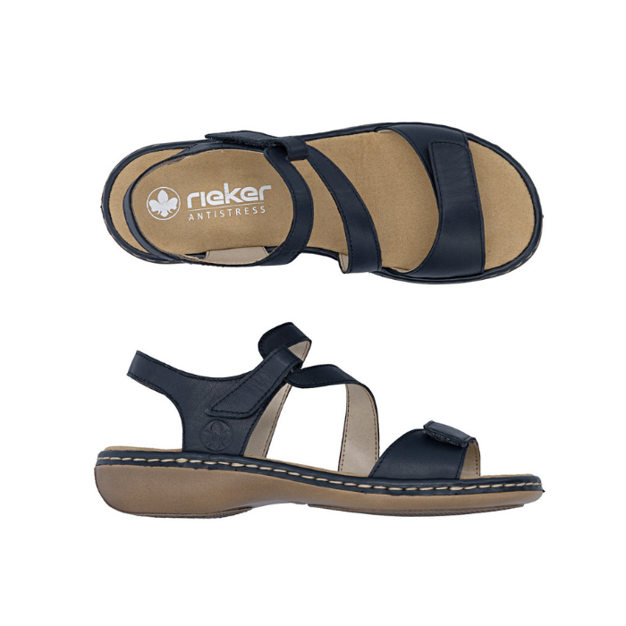 Pair of Navy leather sandals with looping Velcro straps, tan Rieker logo'd footbed and brown outsole.
