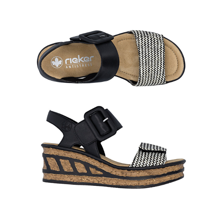Pair of Black wedge sandals with a checkered toe band strap, faux buckle on top Velcro strap and a faux cork wedge midsole with black accent lines.