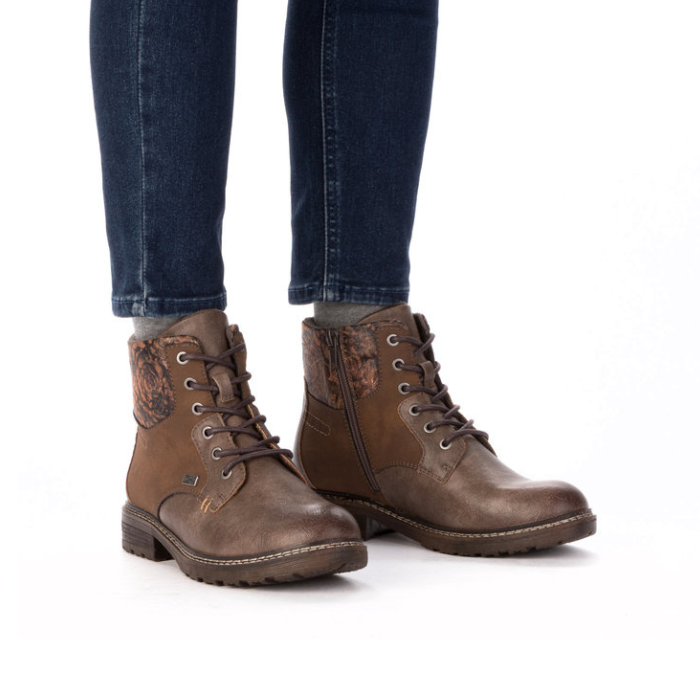 Brown leather boots worn with dark jeans.