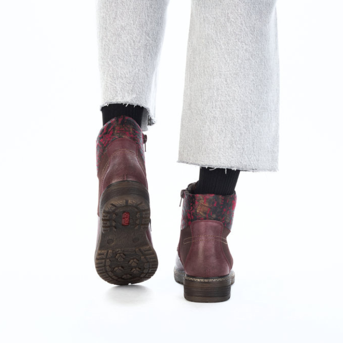Red leather boots worn with white pants.