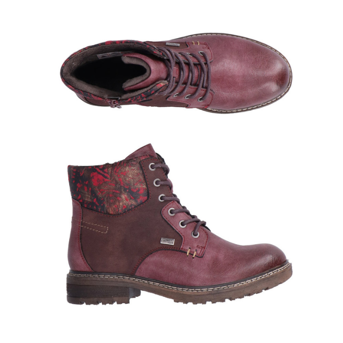 Pair of Burgundy lace-up boots with distressed accents, floral cuff, inside zipper and a low heel.