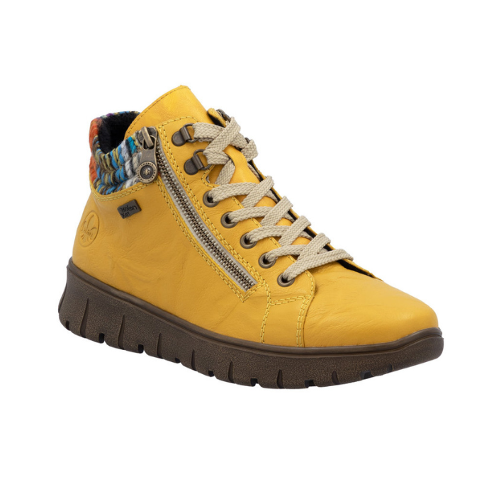 Yellow ankle boot with a zipper, beige laces, multi-color knit cuff and brown light treaded outsole.