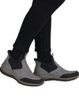 Gray and black ankle boots worn with black pants.
