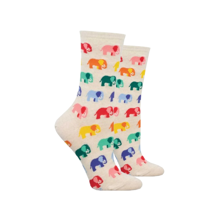A pair of cream-colored crew socks with a colorful pattern of small elephants in red, pink, orange, green, blue, and yellow.