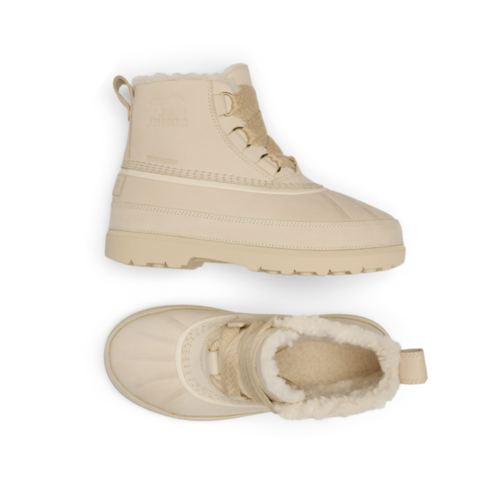Pair of Tan ankle boots with thick rubber outsole, thick decorative laces and faux fur poking out of top.