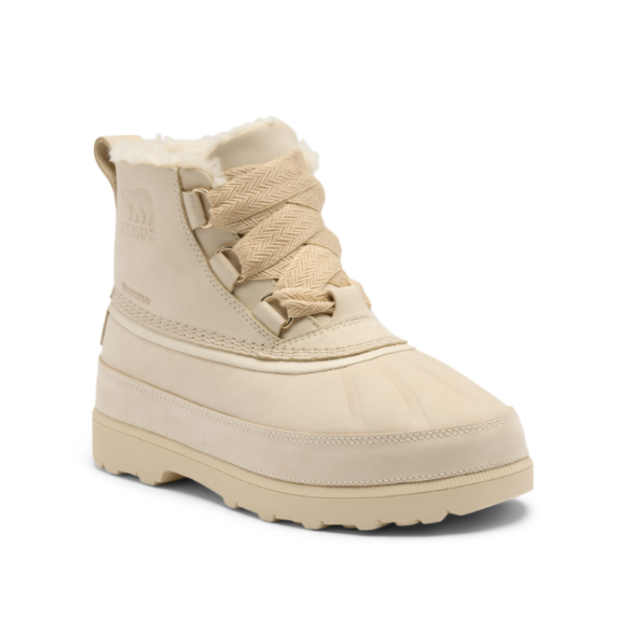 Tan ankle boot with thick rubber outsole, thick decorative laces and faux fur poking out of top.