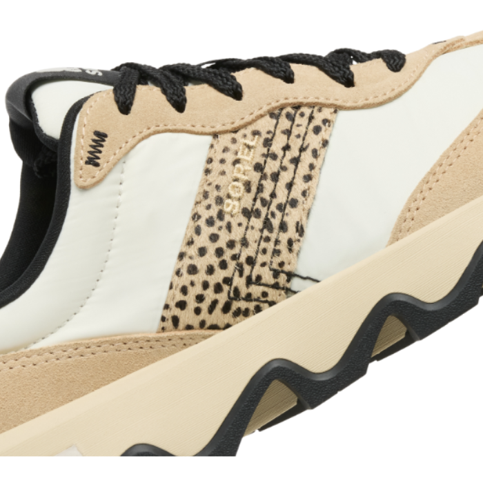 Close-up of a side of sneaker with cheetah print, beige, black, and white upper.