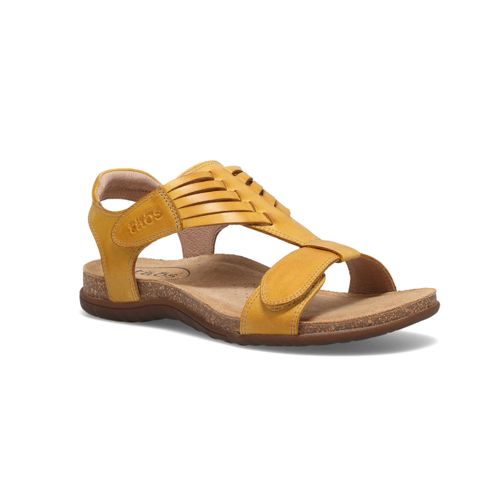 Yellow backstrap sandal with woven details on t-strap, tan Taos logo'd footbed and brown rubber outsole.