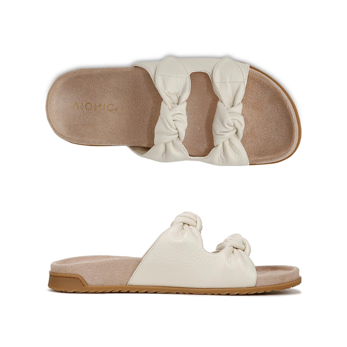 Pair of Slide Sandals in ivory with dual knotted straps, tan Vionic logo'd footbed, and black rubber outsole.
