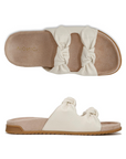 Pair of Slide Sandals in ivory with dual knotted straps, tan Vionic logo'd footbed, and black rubber outsole.