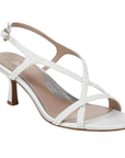 White kitten heel with thin criss-crossing pearl lined straps, buckle closure, and tan Naturalizer logo'd footbed.