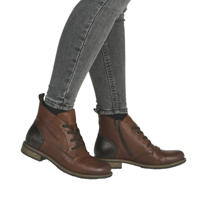 Brown leather boots worn with gray jeans.