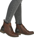 Brown leather boots worn with gray jeans.