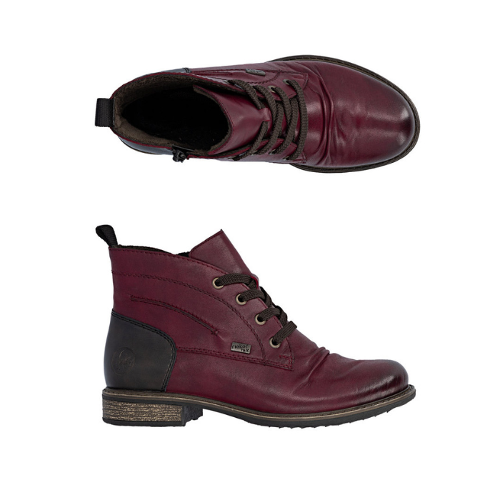 Pair of Maroon leather lace boots with brown laces, inside zipper, black heel cap and brown low outsole.