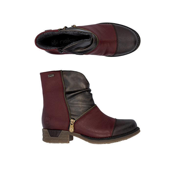 Pair of Women's ankle boots in red and brown with asymmetrical faux zipper and low heel.