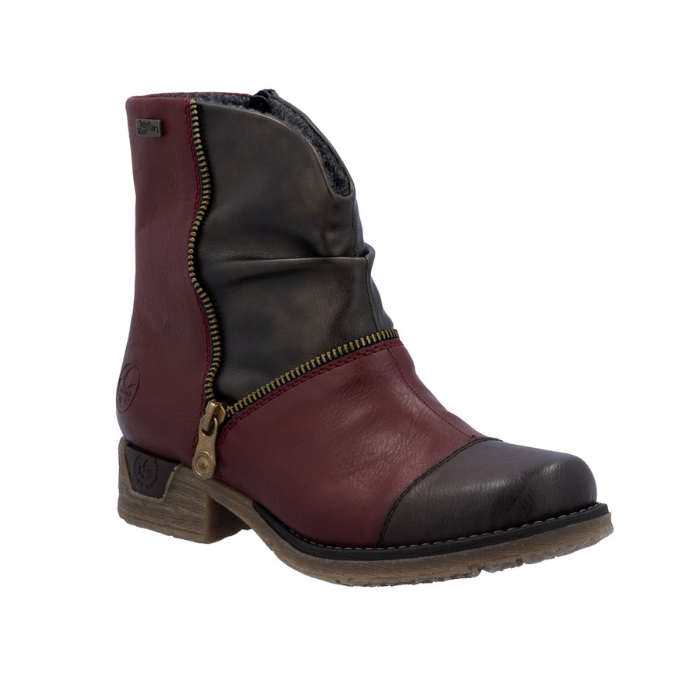 Women's ankle boot in red and brown with asymmetrical faux zipper and low heel.