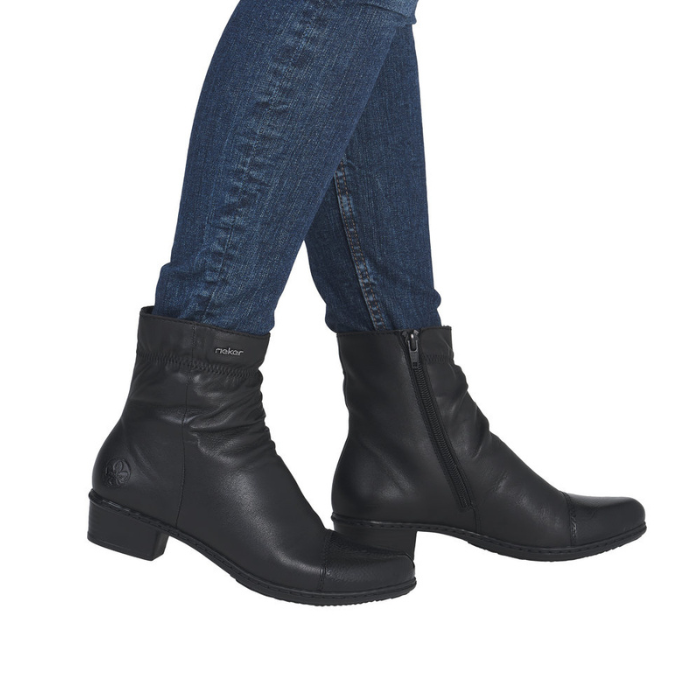 Black leather boots  with gathering details worn with blue jeans.
