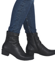 Black leather boots  with gathering details worn with blue jeans.