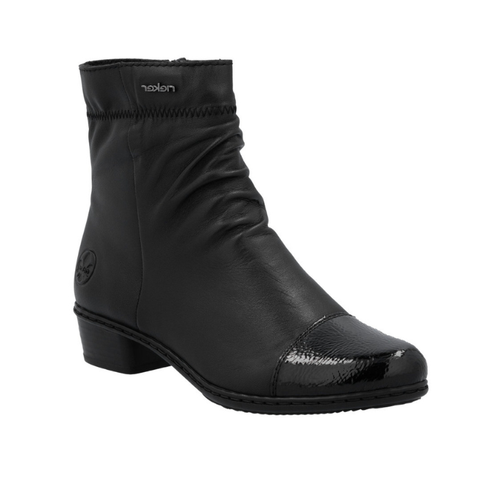 Black leather ankle boot with gathering at instep, black patent toe cap and low heel.