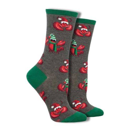 Socksmith Women's Festive Lobsters Socks featuring red lobsters in holiday hats and scarves on a gray background with green accents. Perfect for holiday cheer and available at White-Balmer Shoes.