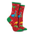 Colorful dinosaurs in Santa hats decorating Christmas trees on a red pair of socks with green accents. 
