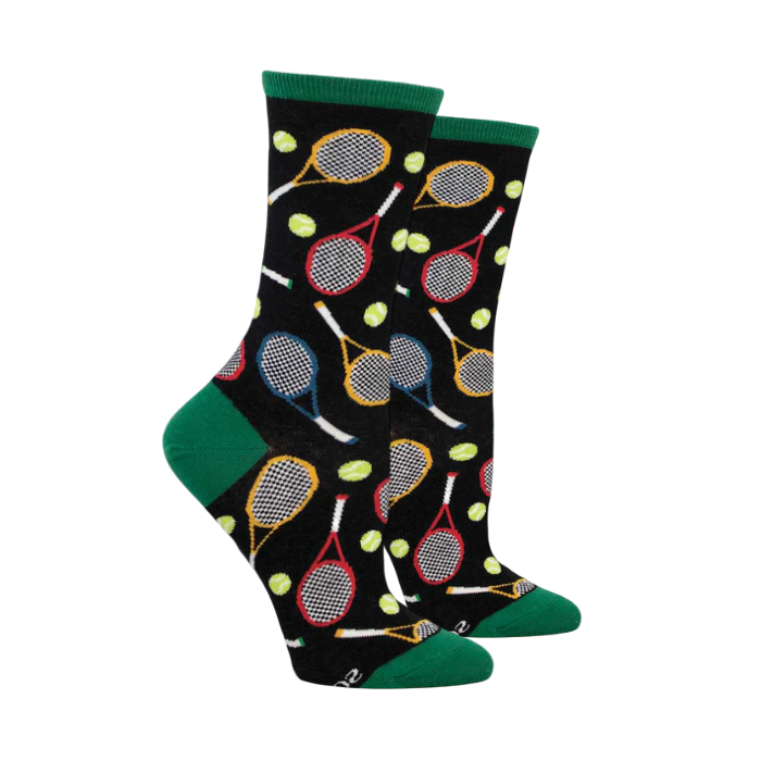 Socksmith Women's Time For Tennis Socks featuring colorful tennis rackets and balls on a black background with green accents. Perfect for sports enthusiasts.