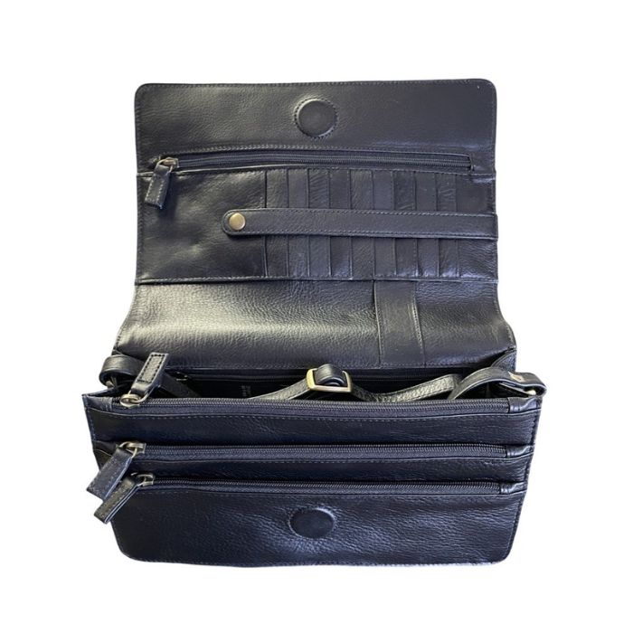 Inside black leather cross body bag showing multiple compartments and card slots.