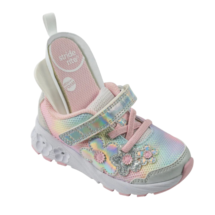 A children's sneaker in pastel pink, yellow, and blue with floral applique and a Velcro strap closure. insoles sticking out to show options and a white outsole that has light up flowers.