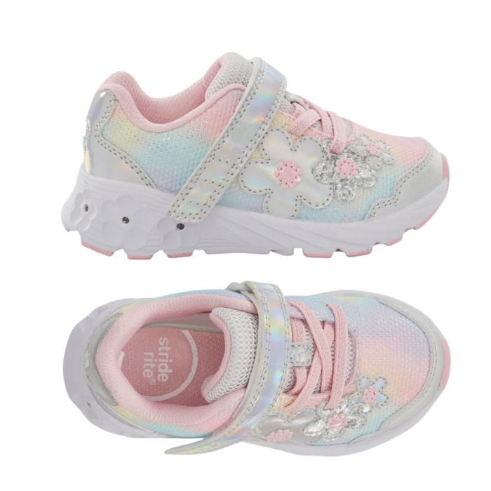 Pair of A children's sneakers in pastel pink, yellow, and blue with floral applique and a Velcro strap closure with a white outsole that has light up flowers.