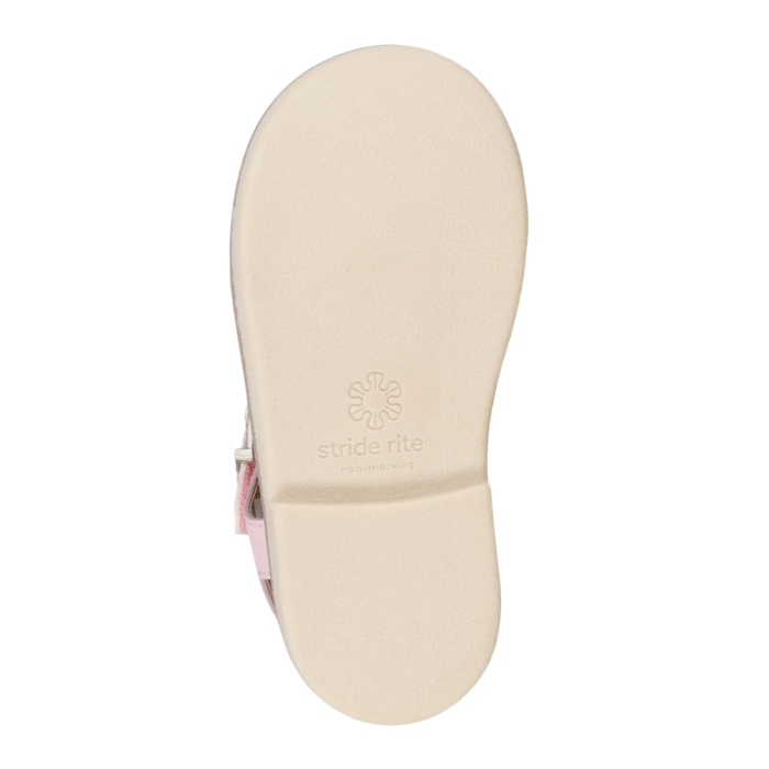 Beige outsole with minimal tread and Stride Rite logo stamped on middle.