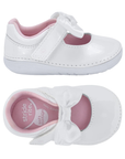 Pair fo A white patent leather baby Mary Jane shoes with a white satin bow on the strap and a pink interior lining.