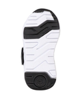 Black and white light treaded outsole of kid's sneaker.