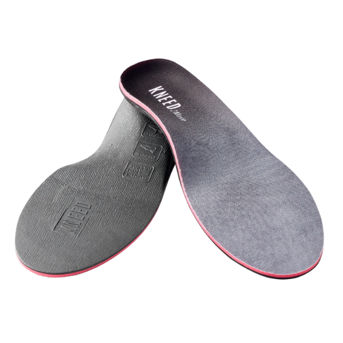 Pair of Black insoles with red layer and "Kneed2Move" text at heel.